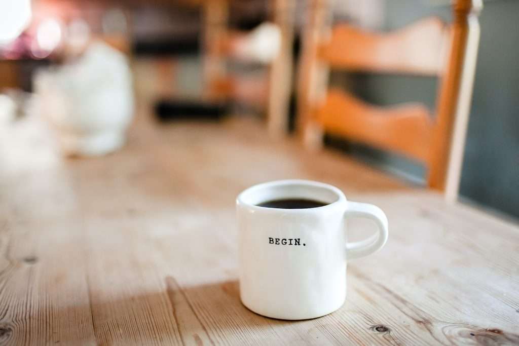 Picture of a coffee mug that says "begin"